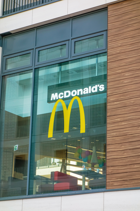 Stuttgart, Germany - November 1, 2015: McDonald's fast food restaurant - window with logo and brand of the fast food chain. The McDonald's Corporation is the world's largest chain selling hamburgers and fast food.